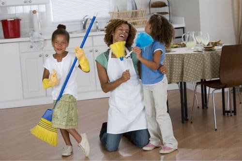 Family dancing while cleaning