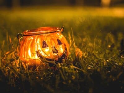 Glowing pumpkin in grass